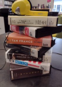 stack of physical audiobooks